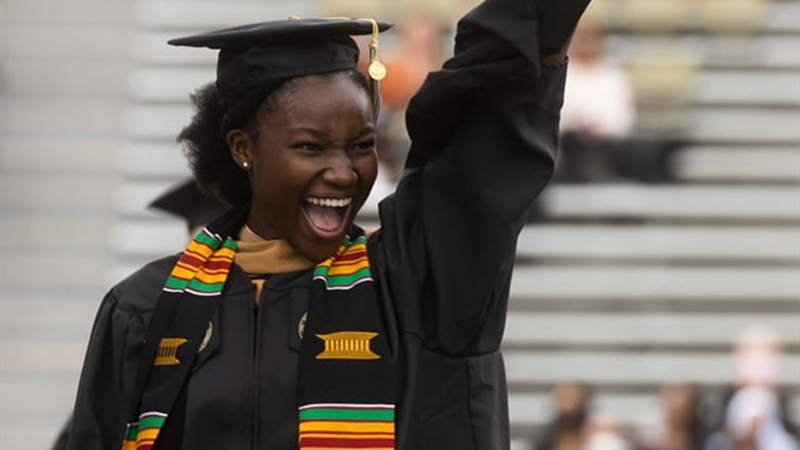 A young Black woman celebrating graduating from Tech.